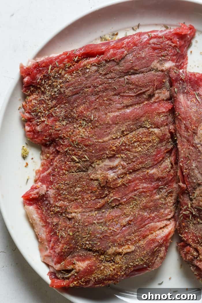 Seasoned skirt steak coated with salt, pepper, and garlic powder.