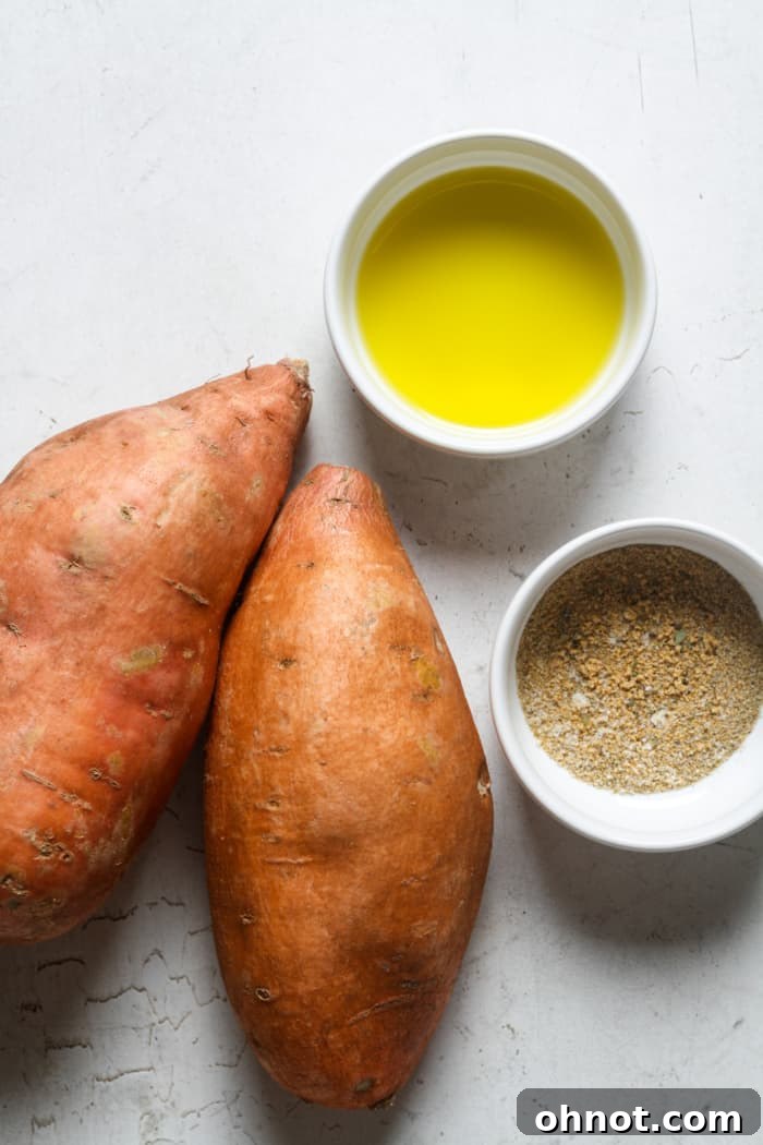 Ingredients for air fryer sweet potato fries laid out on a wooden surface.