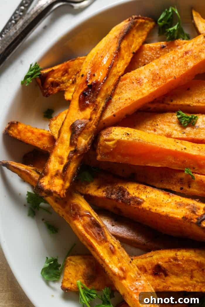 A close-up of perfectly crispy sweet potato fries, highlighting their golden texture.