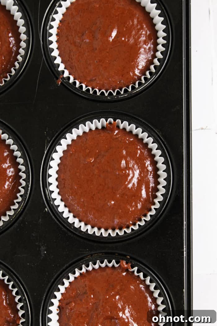 Cupcake pan with red batter.