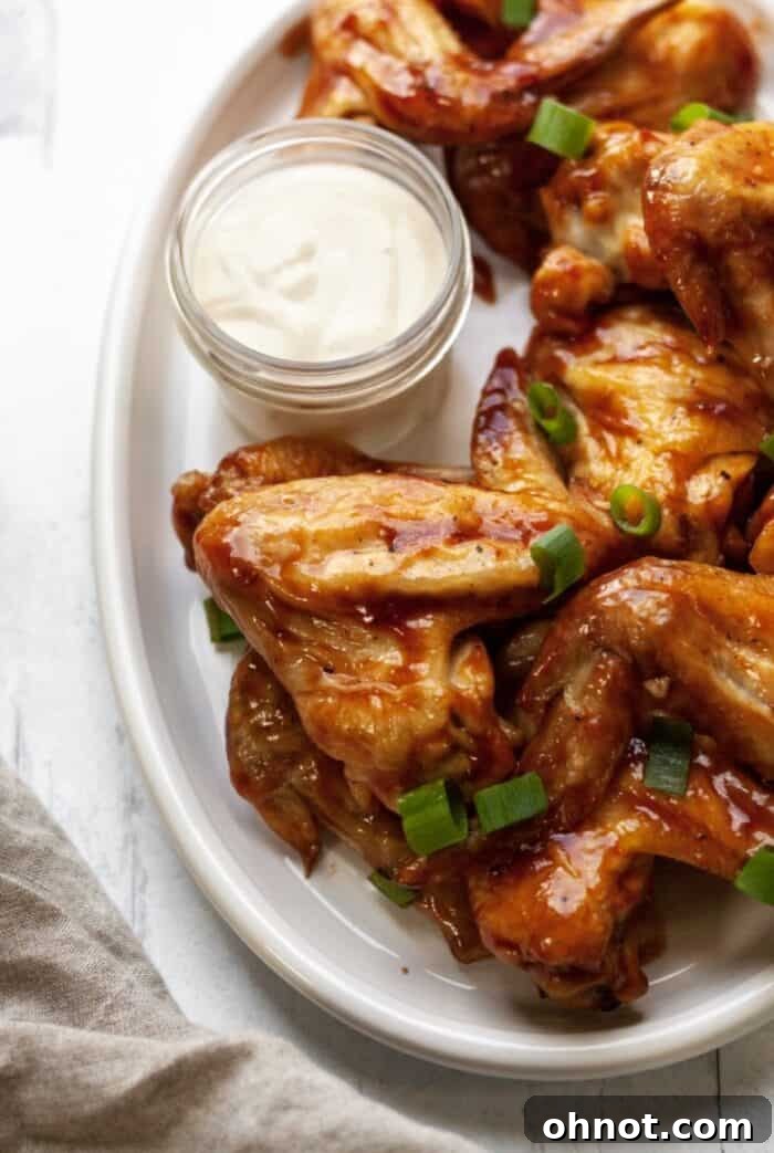 Paleo BBQ wings on plate with a side of Whole30 dipping sauce