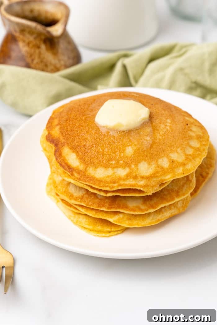 A tall stack of fluffy keto pancakes, invitingly presented.