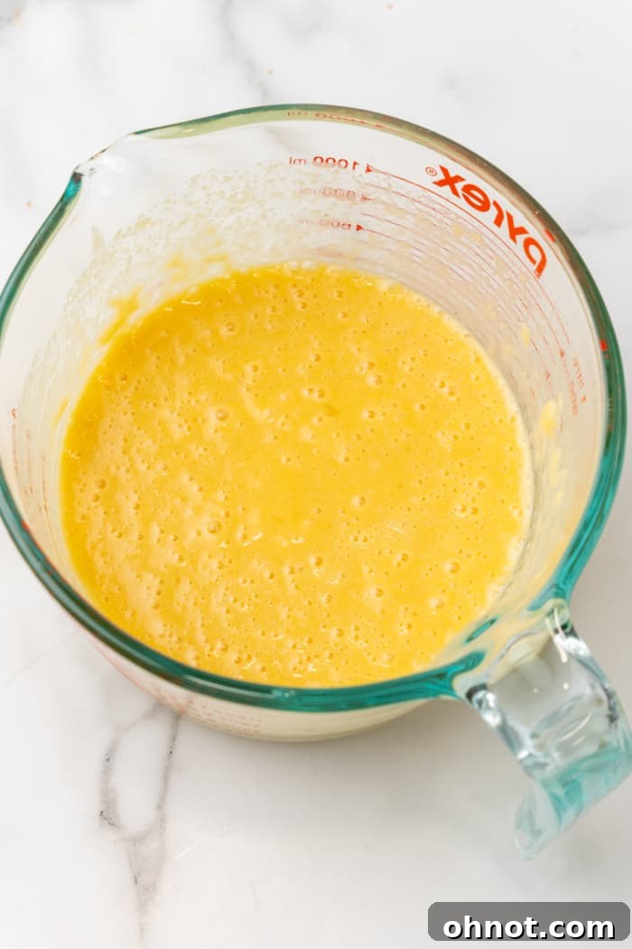 Smooth yellow pancake batter in a bowl.