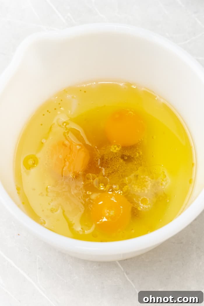 Eggs and olive oil in a bowl ready for mixing.