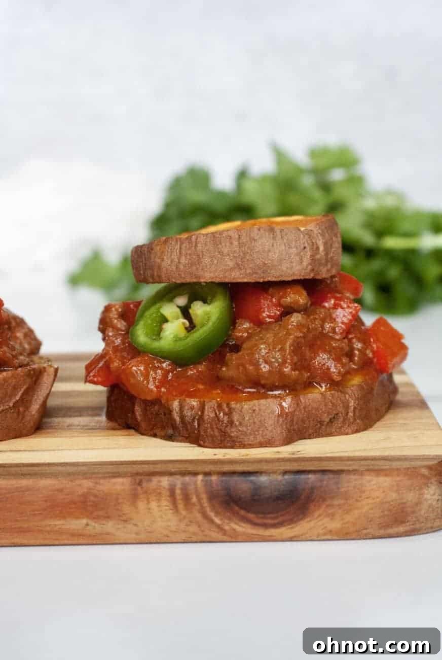 Plate of three Sweet Potato Sloppy Joe Sliders with garnishes