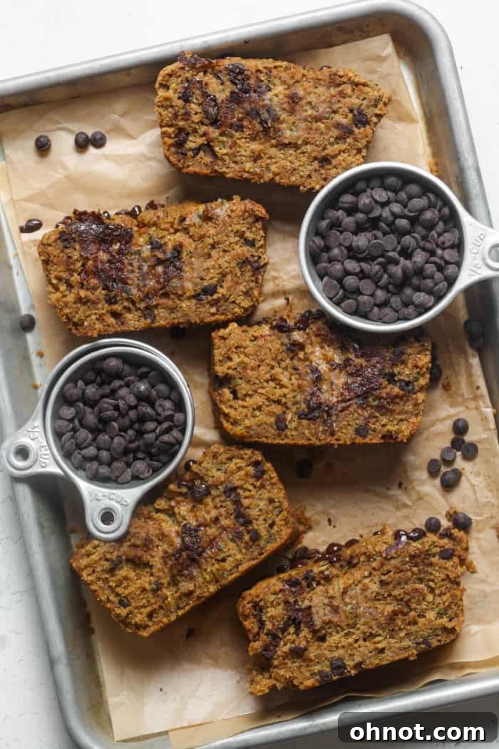 Slices of healthy zucchini loaf on a cutting board, showcasing its rich texture and chocolate chips.