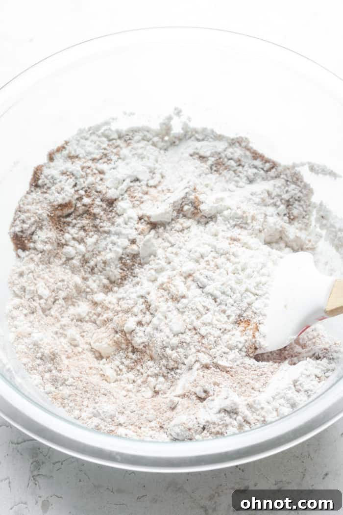 A mixing bowl containing coconut sugar and gluten-free flour, ready to be combined.