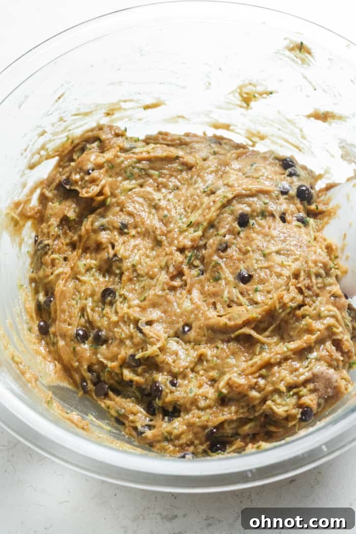 Zucchini bread batter with mini chocolate chips folded in, ready for the pan.