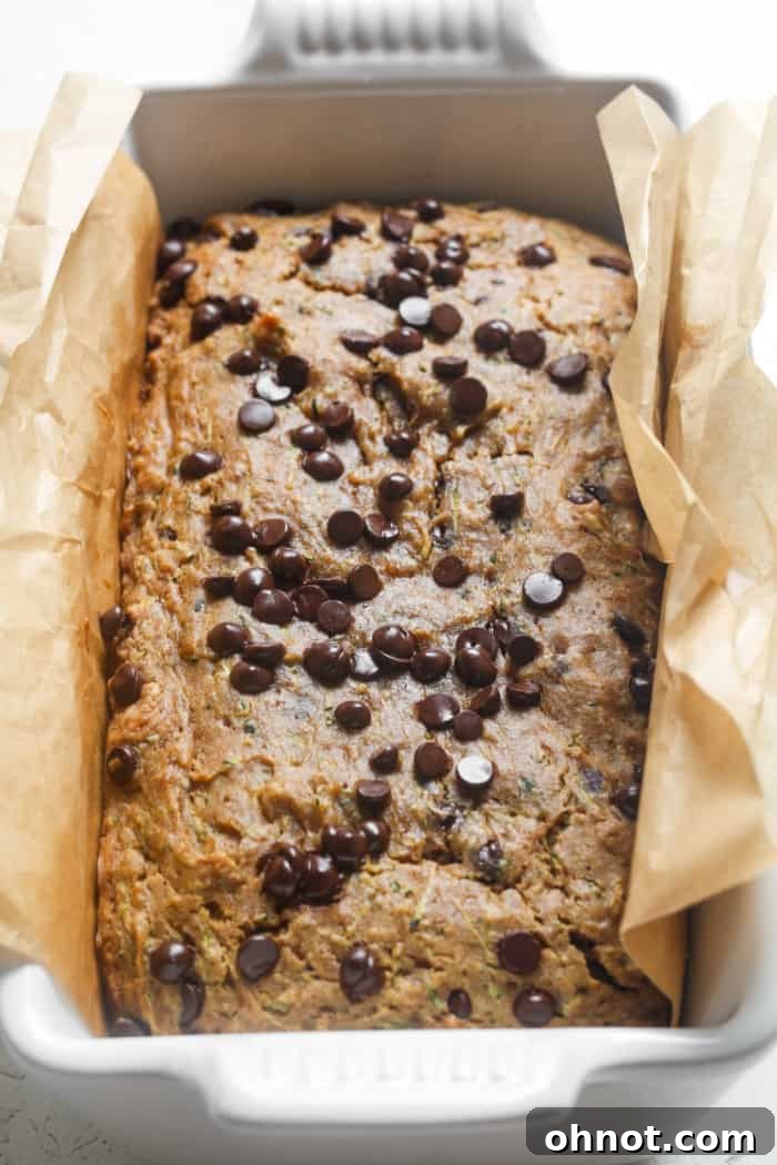 A perfectly baked loaf of healthy zucchini bread, golden brown and risen.