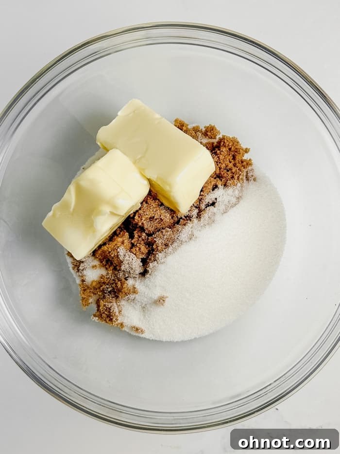Creaming butter, brown sugar, and white sugar until light and fluffy.