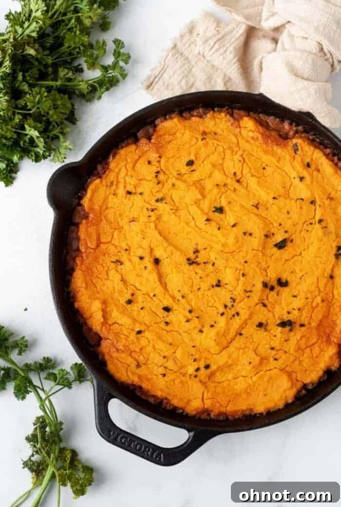 A cast iron skillet filled with golden-brown Whole30 Shepherd's Pie, ready to serve.