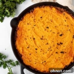 A cast iron skillet filled with golden Whole30 Shepherd's Pie.