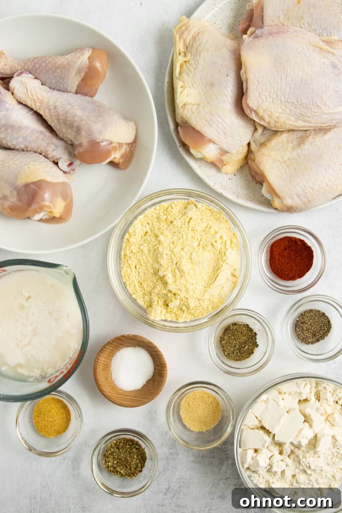 A selection of raw ingredients for gluten-free fried chicken, including chicken pieces, buttermilk, flour, cornmeal, and various spices.