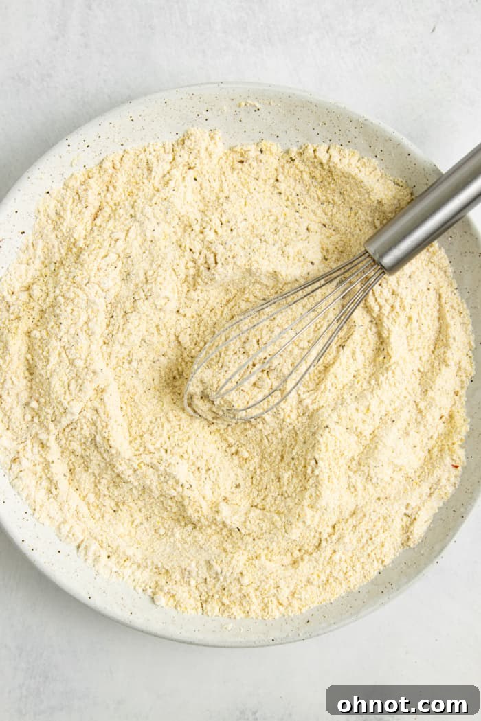 A shallow dish containing the gluten-free breading mixture, ready for coating.