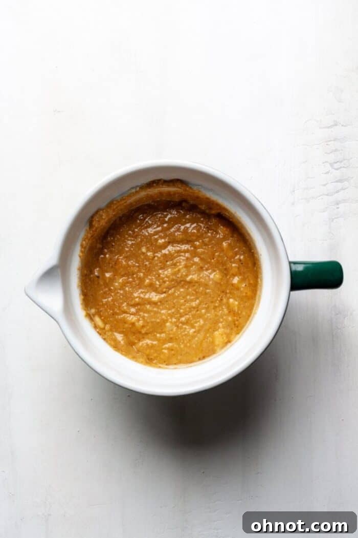 Wet ingredients for banana bread batter in a mixing bowl