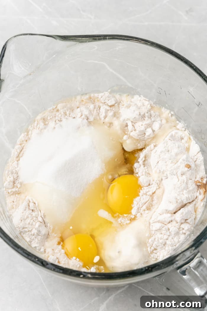 Close-up of a bowl containing flour, eggs, and sugar, waiting to be mixed for crepe batter.