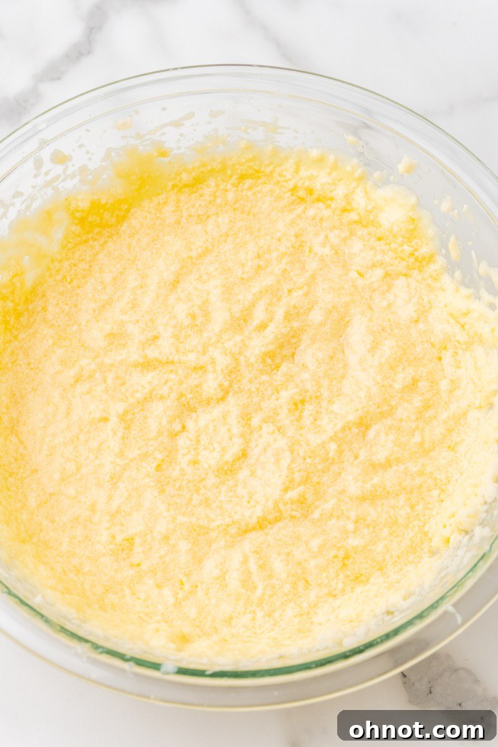 Smooth yellow cake batter in a mixing bowl.