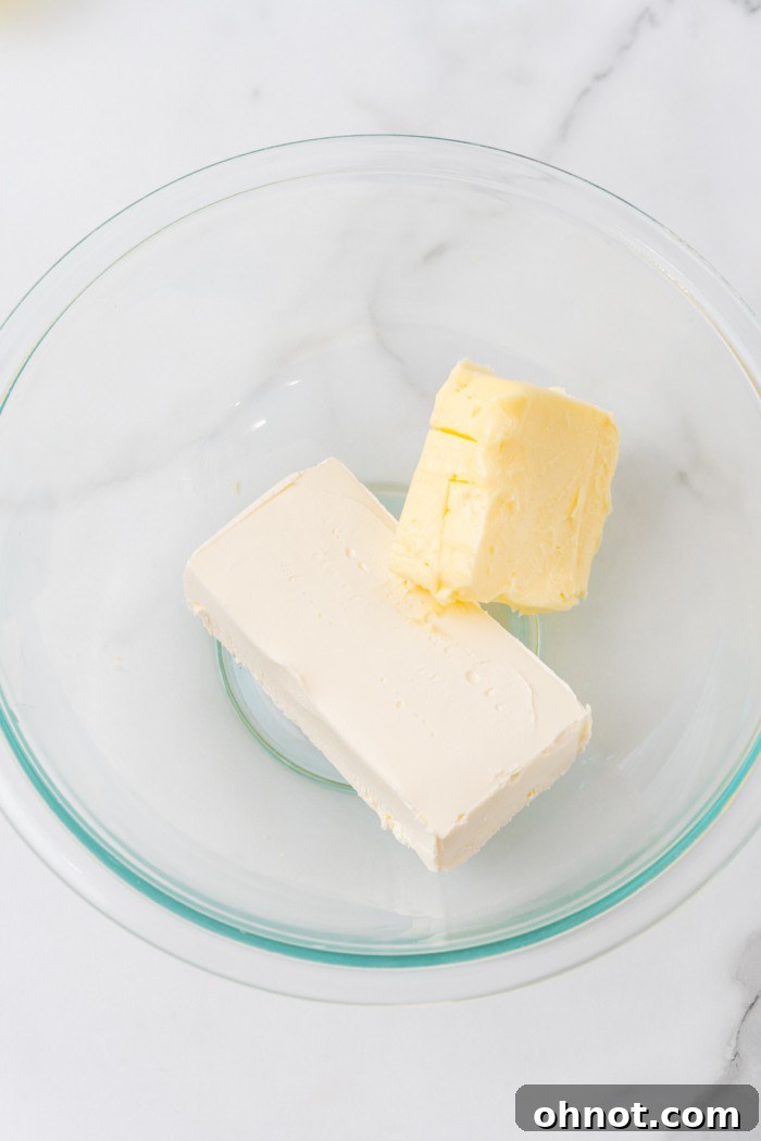 Softened cream cheese and butter in a mixing bowl.