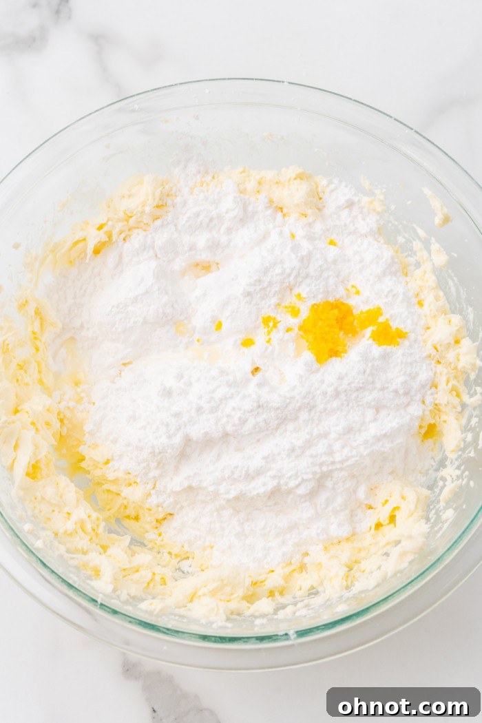 Powdered sugar and lemon zest added to cream cheese and butter mixture.