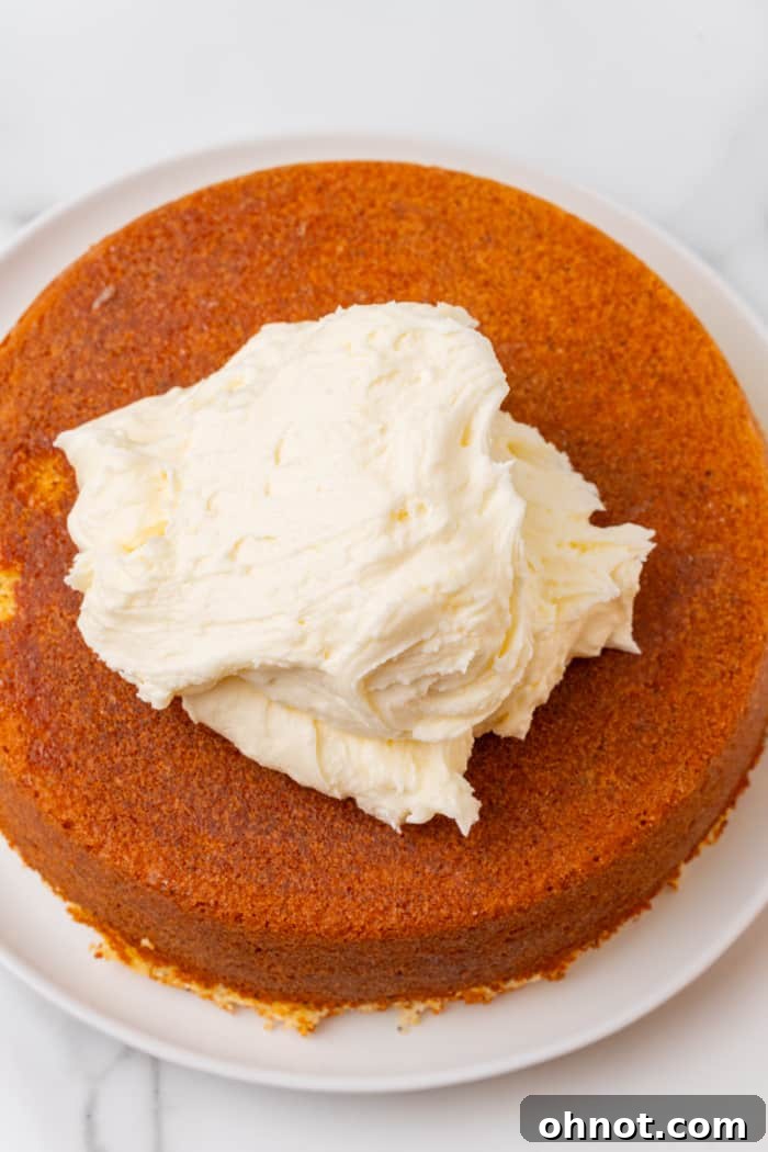 Lemon cream cheese frosting being spread on the cake.