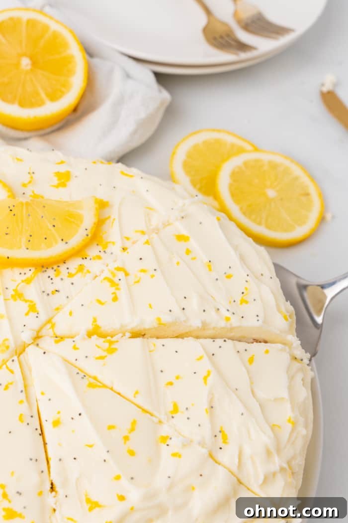 A delectable slice of lemon poppy seed cake on a plate with a fork.