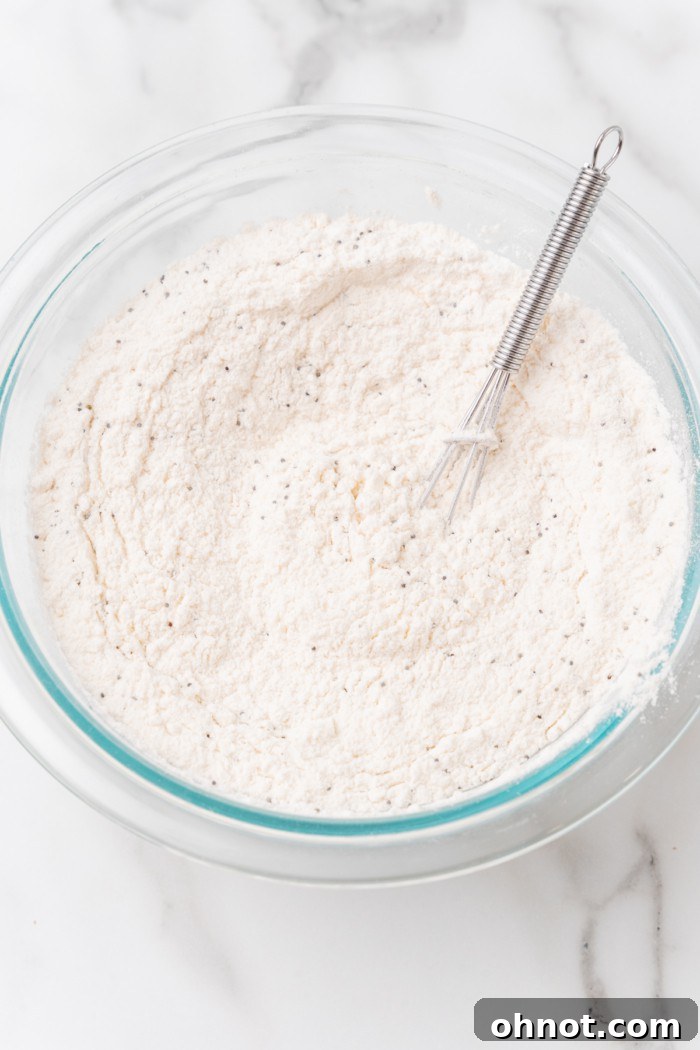 Whisked flour and poppy seeds in a bowl.