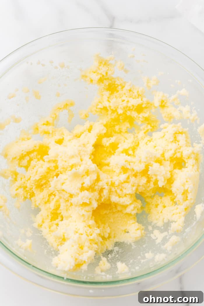 Creamed butter and sugar mixture in a glass bowl.