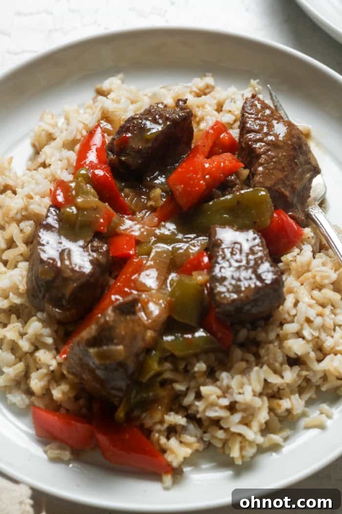 Plate with tender beef tips and rice.