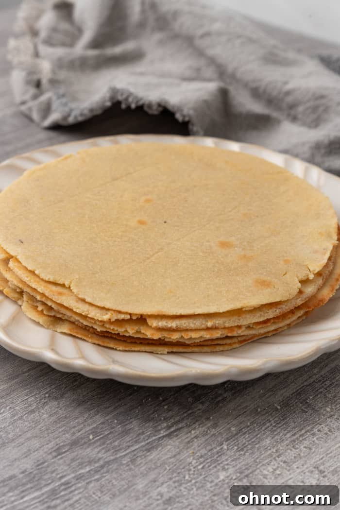A beautiful stack of freshly made almond flour tortillas, showcasing their golden-brown hue and soft texture.