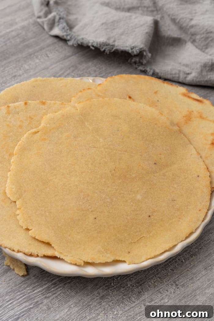 A perfectly stacked pile of paleo-friendly almond flour tortillas, showcasing their inviting texture.
