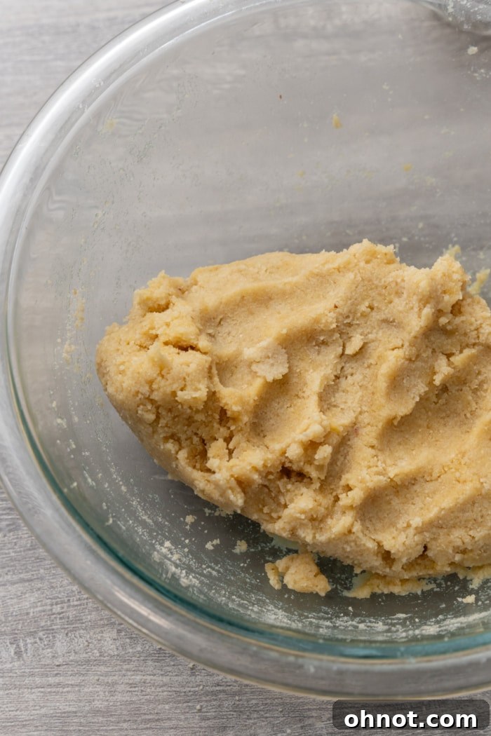 Smooth and pliable almond flour tortilla dough, perfectly formed into a ball in a mixing bowl.