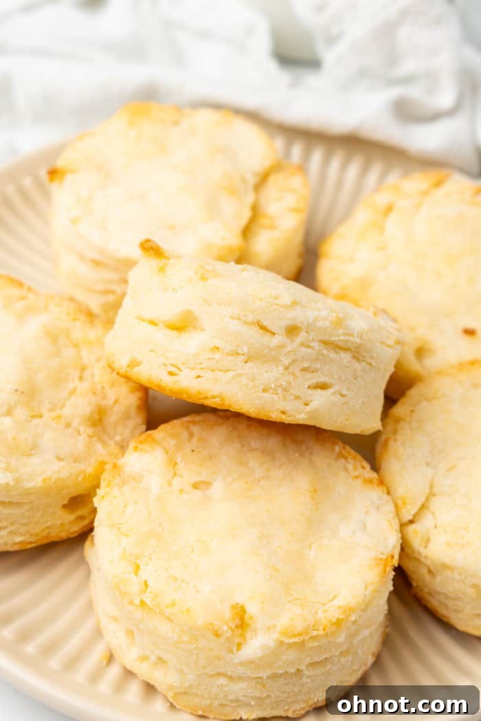 Close-up of soft, fluffy gluten free biscuits, some split open, ready for butter.