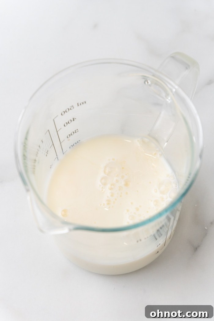 Milk in a tall measuring cup.