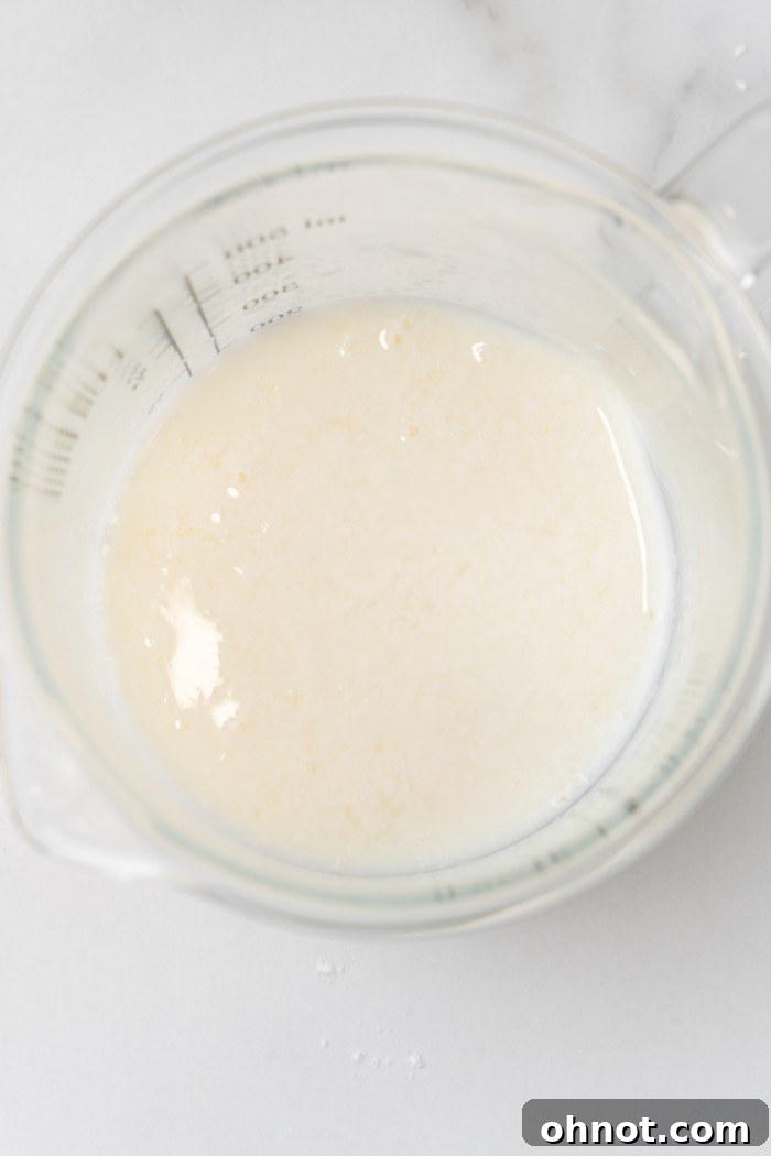 Milk and apple cider vinegar mixture in a cup, slightly curdled.