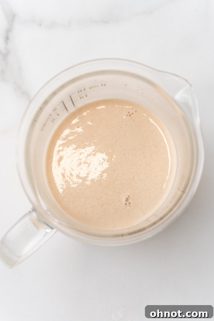 Frothy yeast in cup.