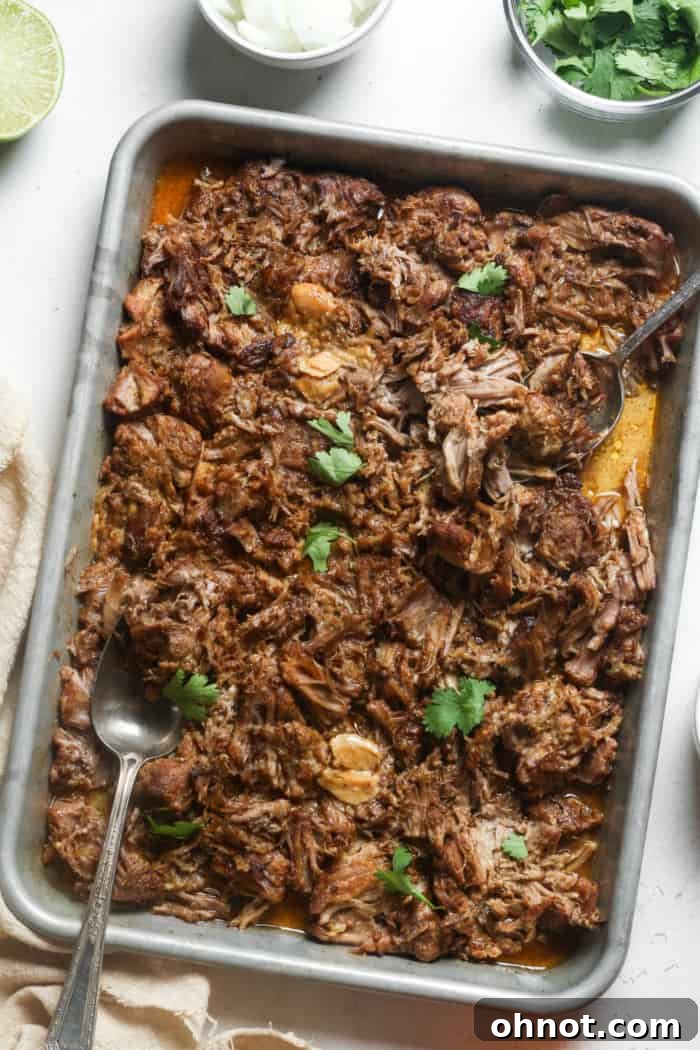 Cooked Instant Pot carnitas in the pressure cooker with broth.