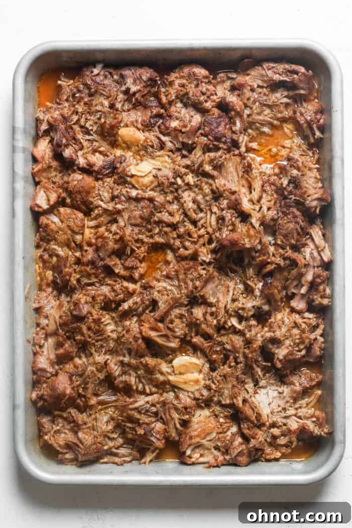 Crispy broiled pork carnitas on a baking sheet.
