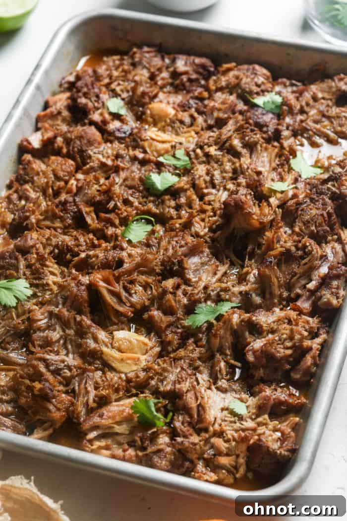 Delicious, crispy carnitas meat arranged on a baking sheet.