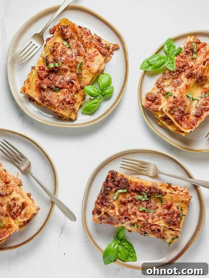 Plates of delicious gluten-free lasagna served, garnished with fresh herbs.