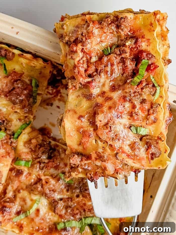 A perfectly sliced piece of gluten-free lasagna, showcasing its beautiful layers.
