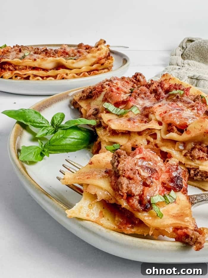 A large baking dish filled with gluten-free lasagna, garnished with fresh herbs, ready to be served.