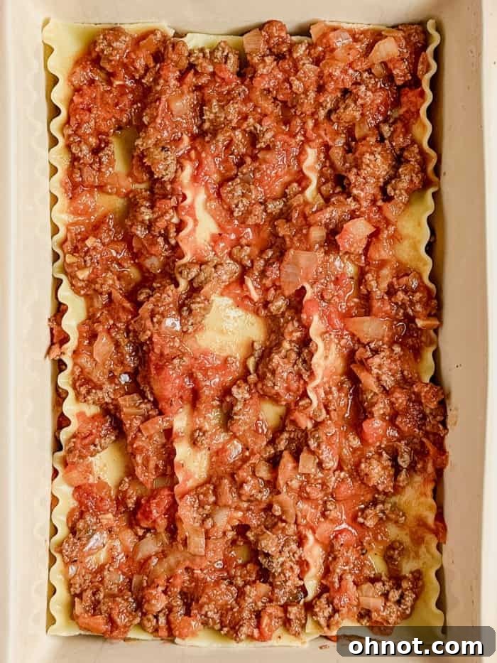 A layer of meat sauce spread over noodles.