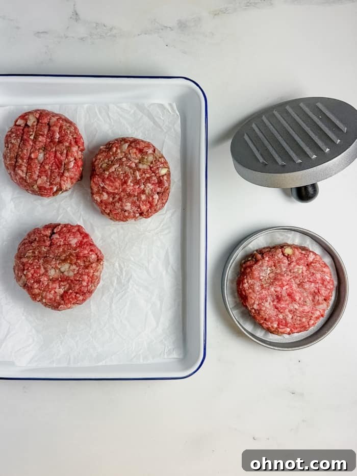 A perfectly shaped hamburger patty fresh out of the burger press.