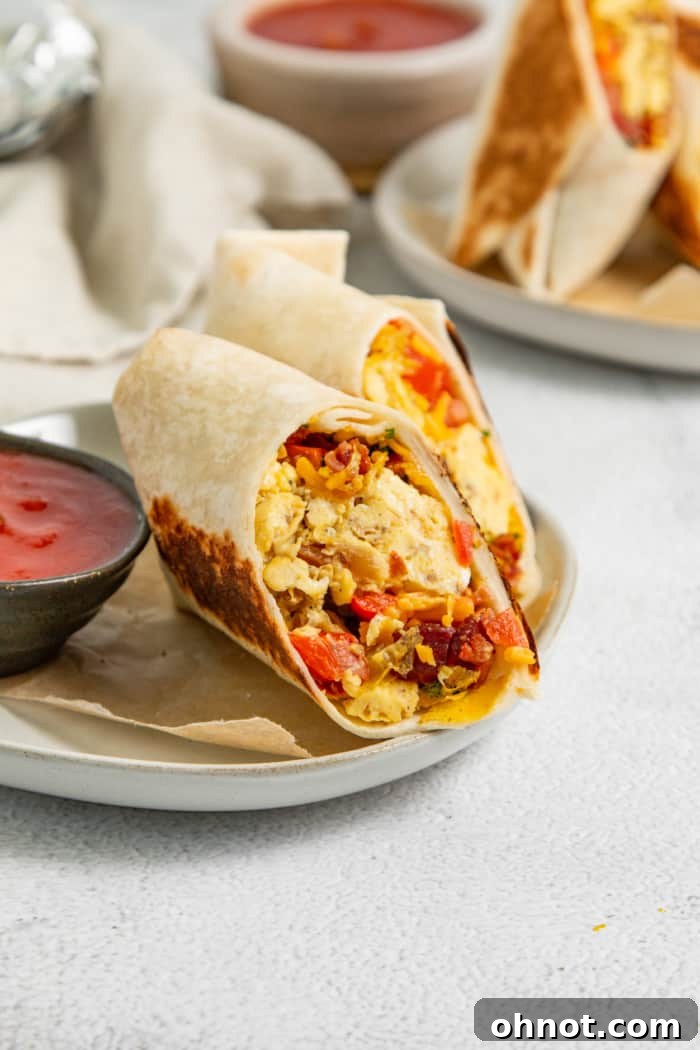 Healthy breakfast burritos artfully arranged on a plate.