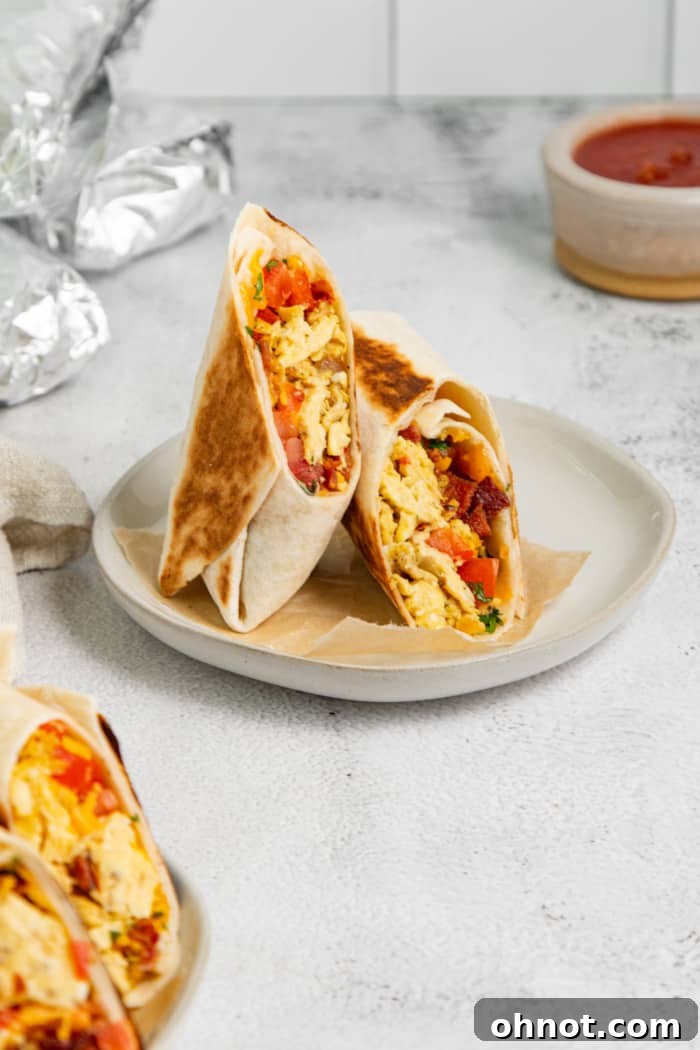 A freshly sliced healthy breakfast burrito revealing its delicious layers.