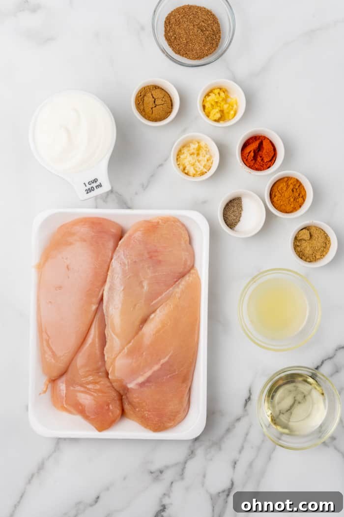 A vibrant array of fresh ingredients and aromatic spices laid out, ready for making Tandoori chicken.