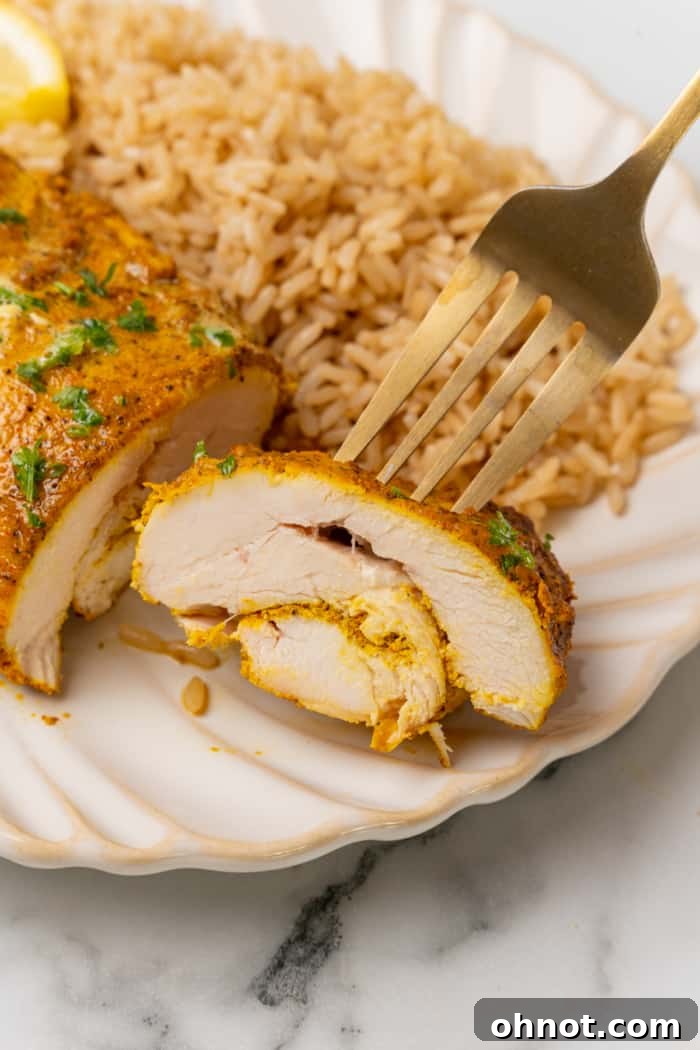 A delectable slice of Tandoori chicken, showing its tender interior and perfectly cooked exterior.