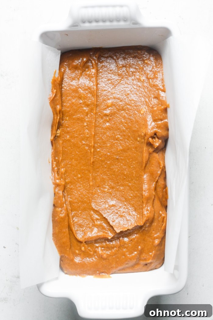 Loaf pan with pumpkin batter.