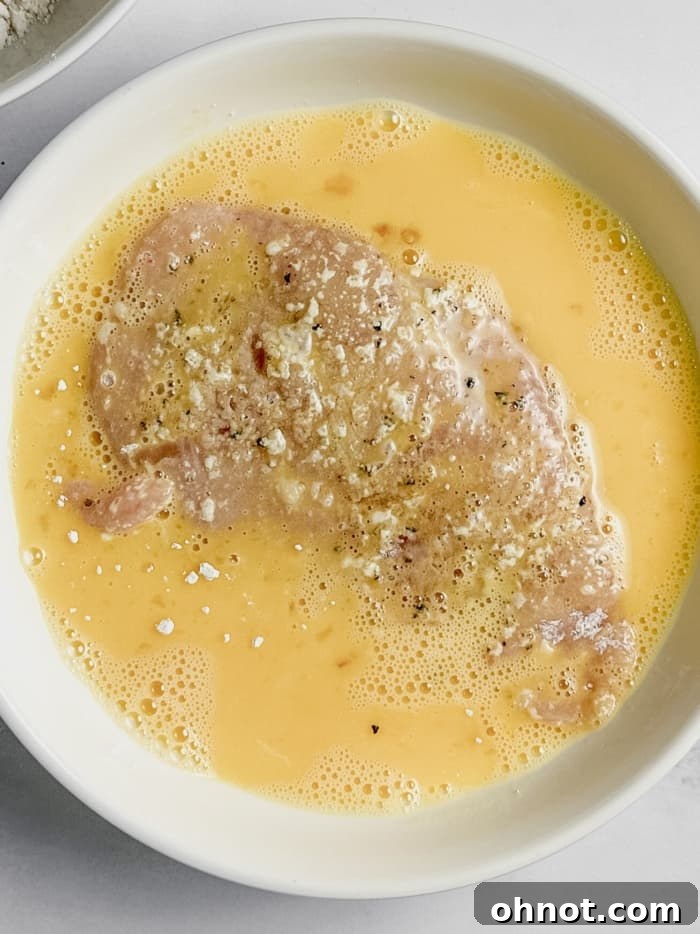 Chicken in whisked egg mixture.