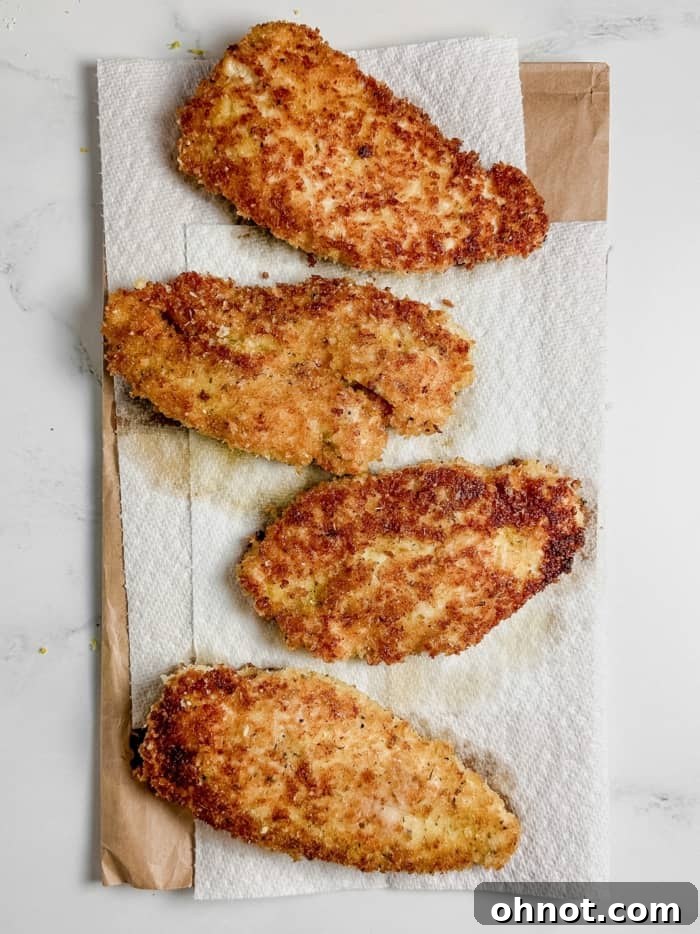 Parmesan chicken on paper towels.